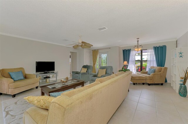 74 Windsor Dr, Englewood, FL 34223 - living room featuring light tile patterned floors, a textured ceiling, crown molding, and a ceiling fan