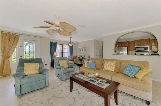 74 Windsor Dr, Englewood, FL 34223 - living area featuring ornamental molding, light tile patterned floors, ceiling fan, and a textured ceiling