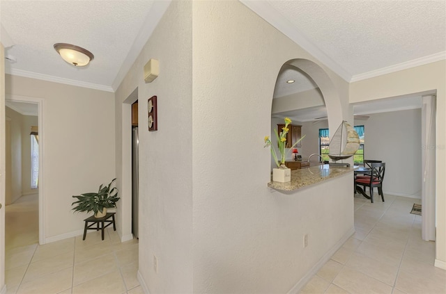 74 Windsor Dr, Englewood, FL 34223 - hallway featuring a textured ceiling, light tile patterned floors, plenty of natural light, and ornamental molding