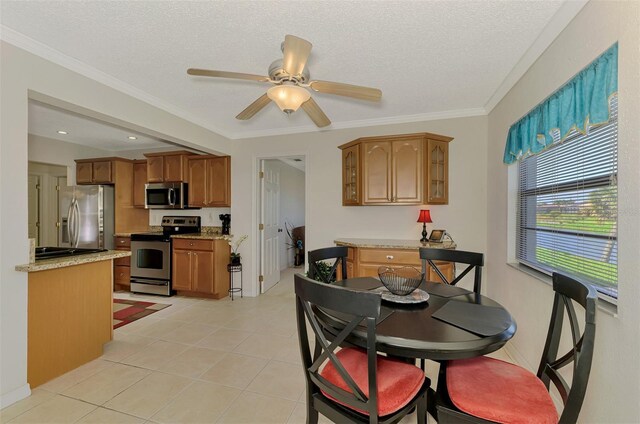 74 Windsor Dr, Englewood, FL 34223 - dining area featuring a textured ceiling, a ceiling fan, light tile patterned floors, and ornamental molding