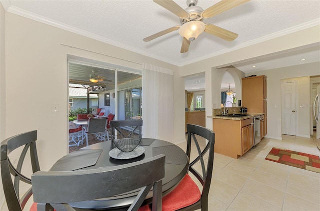 74 Windsor Dr, Englewood, FL 34223 - dining space featuring a ceiling fan, plenty of natural light, light tile patterned floors, and crown molding