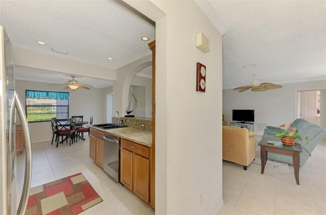 74 Windsor Dr, Englewood, FL 34223 - kitchen with appliances with stainless steel finishes, ceiling fan, open floor plan, a textured ceiling, and light tile patterned floors