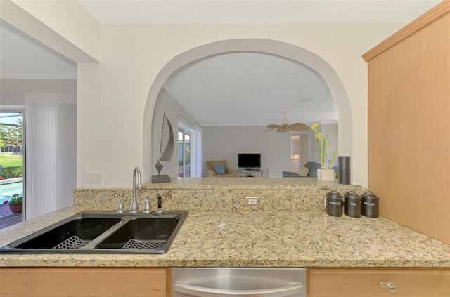 74 Windsor Dr, Englewood, FL 34223 - kitchen with stainless steel dishwasher, arched walkways, healthy amount of natural light, ceiling fan, and crown molding
