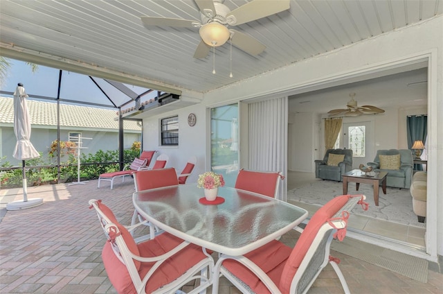 74 Windsor Dr, Englewood, FL 34223 - view of patio / terrace with a ceiling fan, outdoor dining area, and glass enclosure