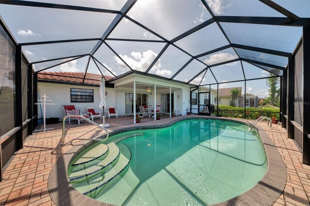 74 Windsor Dr, Englewood, FL 34223 - outdoor pool featuring a patio area and glass enclosure