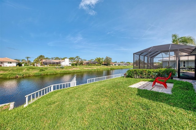 74 Windsor Dr, Englewood, FL 34223 - view of grassy yard featuring a water view, a patio area, glass enclosure, and a residential view