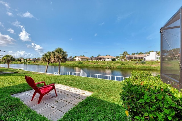74 Windsor Dr, Englewood, FL 34223 - view of grassy yard with a water view, a residential view, a patio area, and glass enclosure