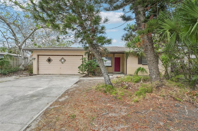 9300 Gulf Blvd, St Pete Beach, FL 33706 - ranch-style home with concrete driveway, stucco siding, and an attached garage