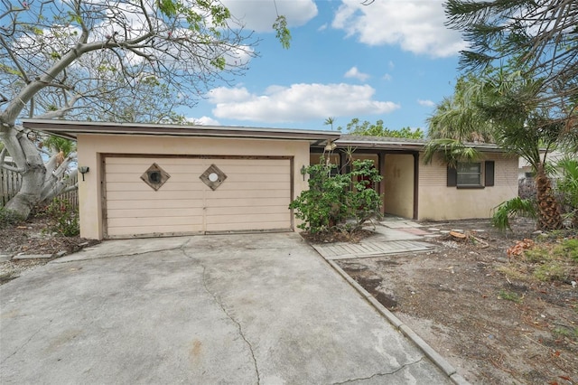 9300 Gulf Blvd, St Pete Beach, FL 33706 - ranch-style house with stucco siding, an attached garage, and driveway