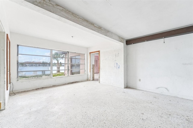 9300 Gulf Blvd, St Pete Beach, FL 33706 - unfurnished room featuring beamed ceiling, a water view, and speckled floor