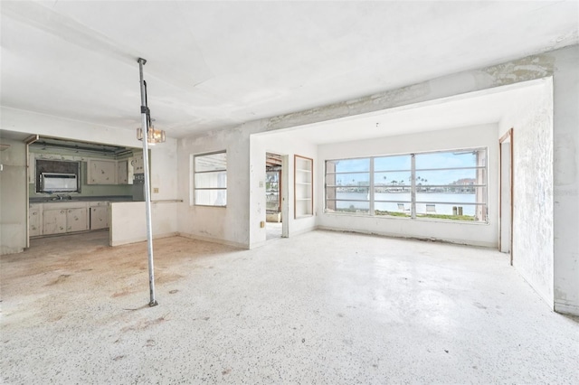 9300 Gulf Blvd, St Pete Beach, FL 33706 - unfurnished living room with a water view