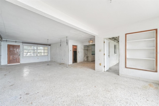 9300 Gulf Blvd, St Pete Beach, FL 33706 - unfurnished living room featuring speckle patterned floor