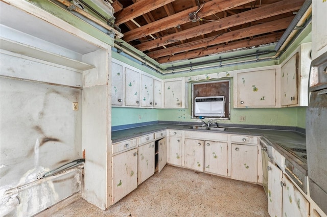 9300 Gulf Blvd, St Pete Beach, FL 33706 - kitchen with dark countertops, a wall mounted air conditioner, and a sink