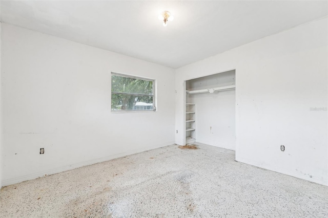 9300 Gulf Blvd, St Pete Beach, FL 33706 - unfurnished bedroom featuring a closet, baseboards, and speckled floor