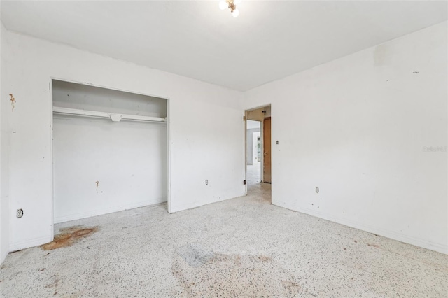 9300 Gulf Blvd, St Pete Beach, FL 33706 - unfurnished bedroom with a closet, speckle patterned floor, and baseboards