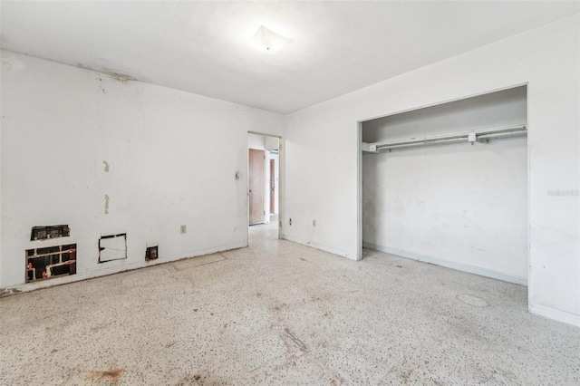 9300 Gulf Blvd, St Pete Beach, FL 33706 - unfurnished bedroom featuring speckled floor, a closet, and baseboards