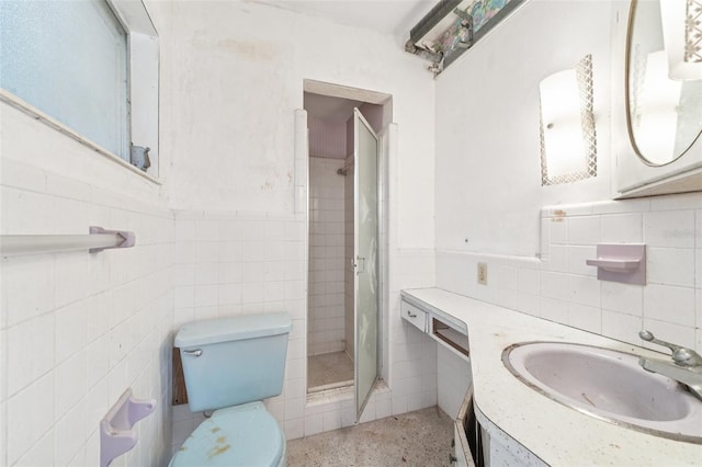 9300 Gulf Blvd, St Pete Beach, FL 33706 - bathroom with tile walls, vanity, a shower stall, toilet, and a wainscoted wall