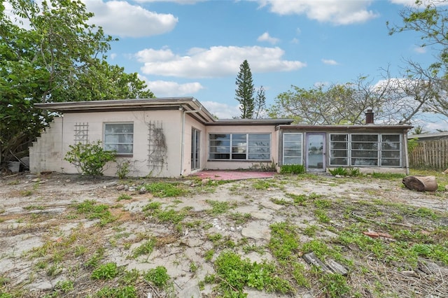 9300 Gulf Blvd, St Pete Beach, FL 33706 - rear view of house featuring a sunroom, concrete block siding, and a patio area