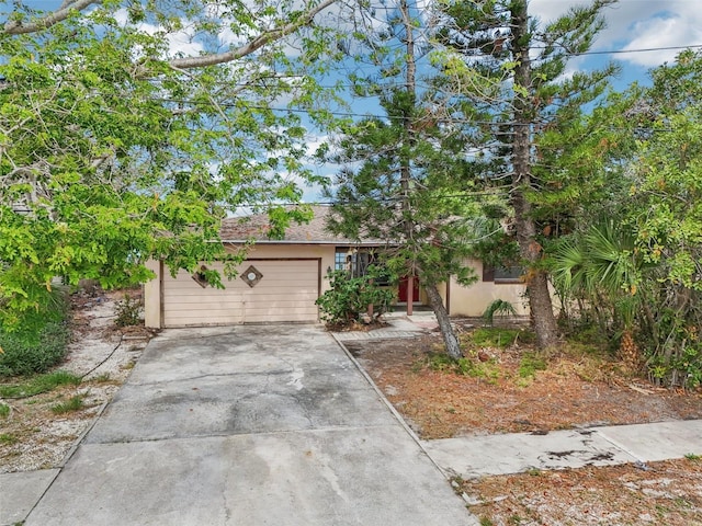 9300 Gulf Blvd, St Pete Beach, FL 33706 - obstructed view of property with driveway and stucco siding