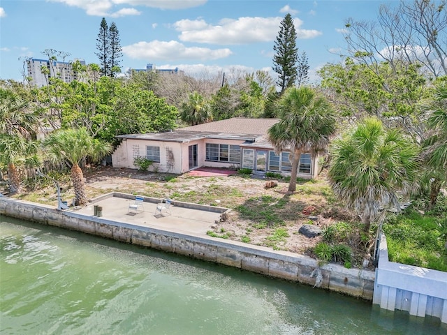 9300 Gulf Blvd, St Pete Beach, FL 33706 - rear view of house featuring a patio area and a water view