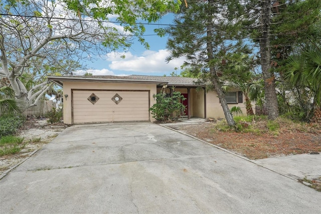 9300 Gulf Blvd, St Pete Beach, FL 33706 - ranch-style home featuring stucco siding, concrete driveway, and a garage