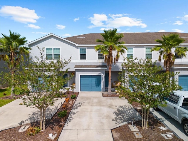 4644 Vignette Way, Sarasota, FL 34240 - view of property featuring stucco siding, concrete driveway, a garage, and a shingled roof
