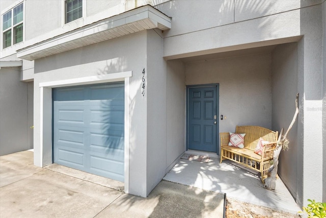 4644 Vignette Way, Sarasota, FL 34240 - view of exterior entry with stucco siding and an attached garage
