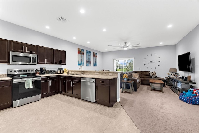 4644 Vignette Way, Sarasota, FL 34240 - kitchen featuring appliances with stainless steel finishes, ceiling fan, open floor plan, dark brown cabinets, and recessed lighting