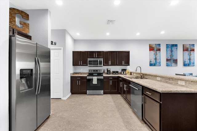 4644 Vignette Way, Sarasota, FL 34240 - kitchen featuring appliances with stainless steel finishes, dark brown cabinetry, recessed lighting, and a peninsula