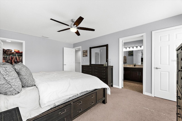 4644 Vignette Way, Sarasota, FL 34240 - bedroom featuring light colored carpet, a spacious closet, ensuite bathroom, a ceiling fan, and a closet