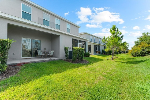 4644 Vignette Way, Sarasota, FL 34240 - rear view of house with stucco siding, a patio area, and a yard