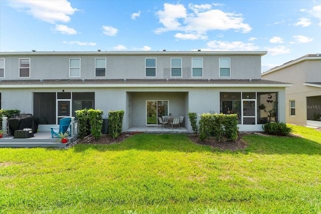 4644 Vignette Way, Sarasota, FL 34240 - rear view of house with stucco siding, a sunroom, a yard, a patio area, and a shingled roof