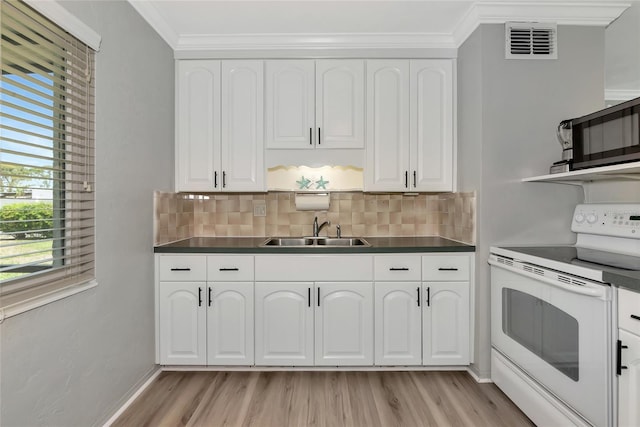 320 59th St W, Bradenton, FL 34209 - kitchen featuring white range with electric cooktop, a sink, open shelves, light wood-style flooring, and ornamental molding