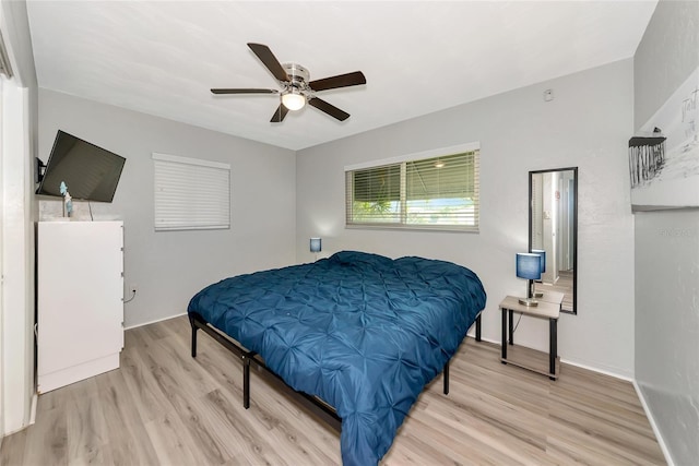 320 59th St W, Bradenton, FL 34209 - bedroom with light wood-style floors, ceiling fan, and baseboards