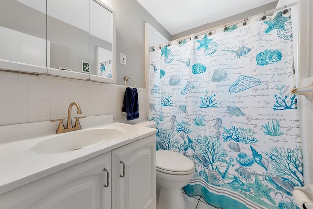 320 59th St W, Bradenton, FL 34209 - bathroom featuring vanity, toilet, a shower with curtain, and tile walls