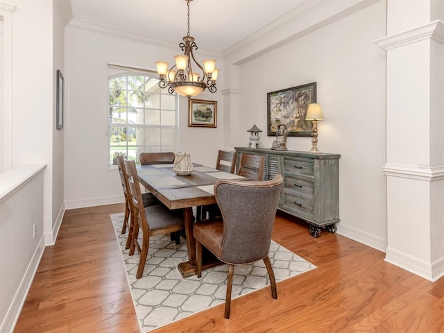 673 Crane Prairie Way, Osprey, FL 34229 - dining space with a chandelier, light wood-style flooring, and crown molding
