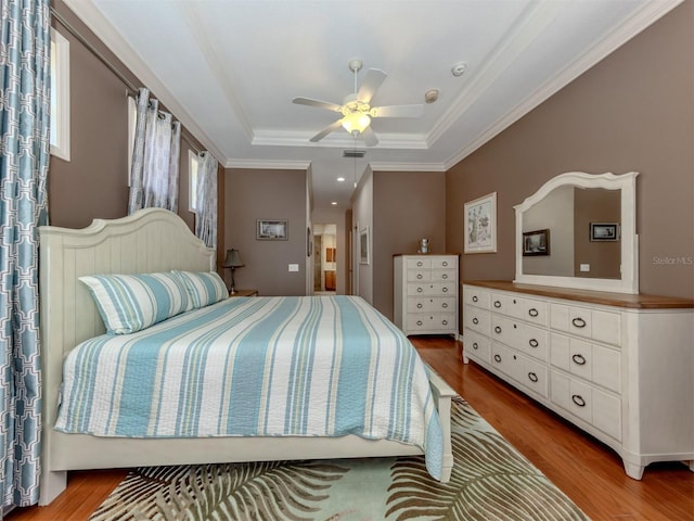 673 Crane Prairie Way, Osprey, FL 34229 - bedroom with wood finished floors, a raised ceiling, crown molding, and a ceiling fan