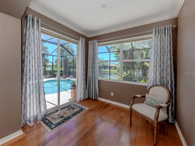 673 Crane Prairie Way, Osprey, FL 34229 - sitting room with wood finished floors, crown molding, and a sunroom