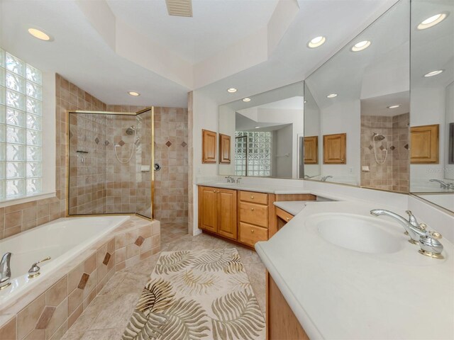 673 Crane Prairie Way, Osprey, FL 34229 - full bathroom with vanity, recessed lighting, a bath, a tile shower, and tile patterned floors
