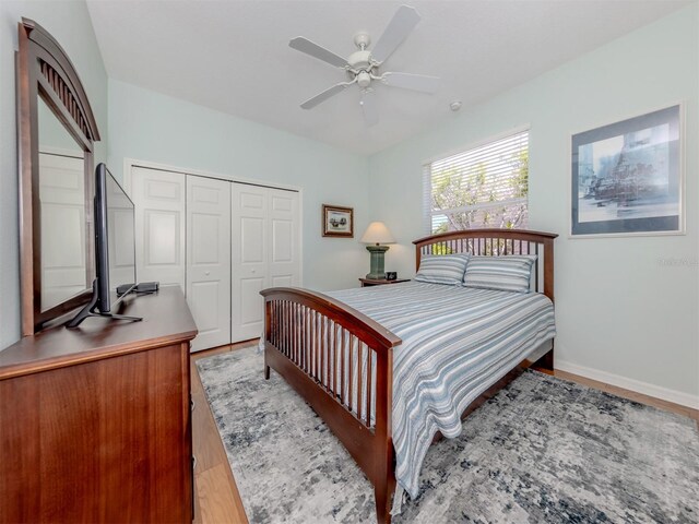 673 Crane Prairie Way, Osprey, FL 34229 - bedroom featuring wood finished floors, a closet, and ceiling fan