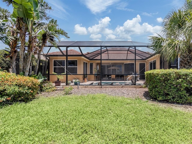 673 Crane Prairie Way, Osprey, FL 34229 - back of property with a tiled roof, a yard, glass enclosure, and a patio