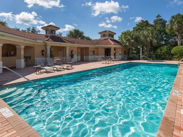 673 Crane Prairie Way, Osprey, FL 34229 - community pool featuring a patio area