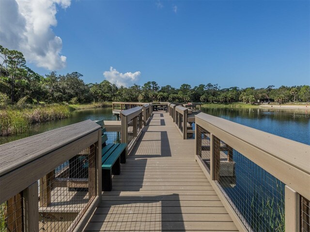 673 Crane Prairie Way, Osprey, FL 34229 - dock area with a water view and view of scattered trees
