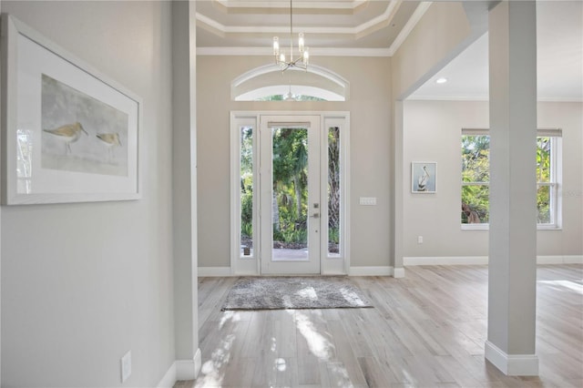 5018 Hanging Moss Ln, Sarasota, FL 34238 - foyer featuring crown molding, a chandelier, and wood finished floors