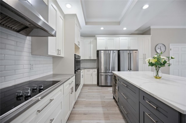 5018 Hanging Moss Ln, Sarasota, FL 34238 - kitchen featuring wall chimney exhaust hood, freestanding refrigerator, ornamental molding, gray cabinets, and black electric stovetop
