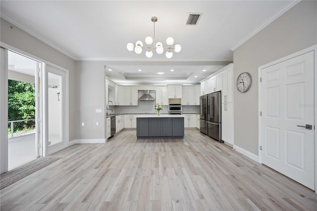 5018 Hanging Moss Ln, Sarasota, FL 34238 - kitchen with stainless steel appliances, ornamental molding, wall chimney exhaust hood, white cabinets, and light countertops