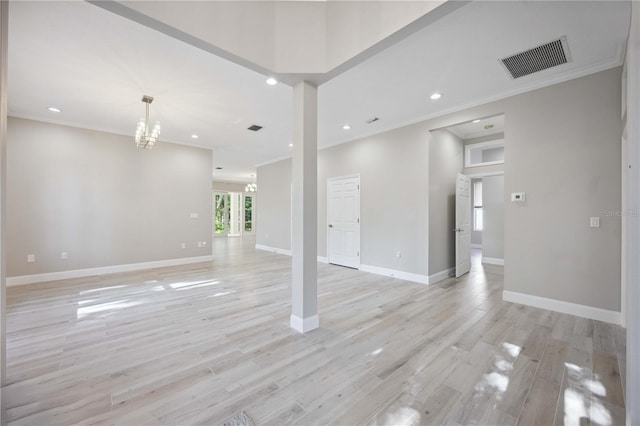 5018 Hanging Moss Ln, Sarasota, FL 34238 - unfurnished living room with crown molding, a chandelier, recessed lighting, and light wood-style flooring