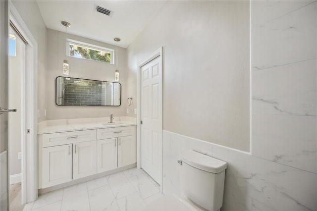 5018 Hanging Moss Ln, Sarasota, FL 34238 - full bath with vanity, marble finish flooring, and wainscoting