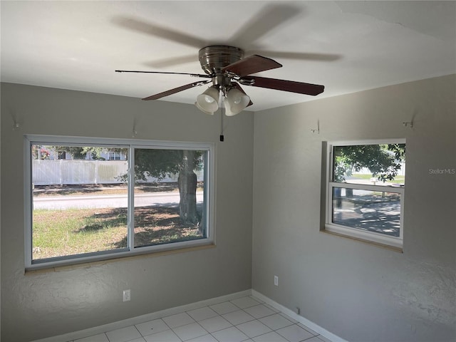 8075 48th Ave N, Saint Petersburg, FL 33709 - unfurnished room featuring healthy amount of natural light, light tile patterned floors, and ceiling fan
