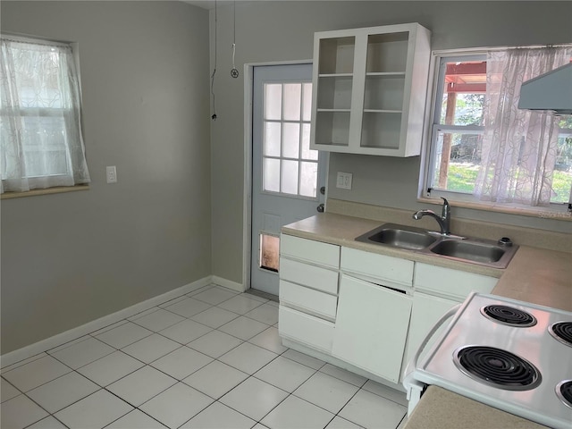 8075 48th Ave N, Saint Petersburg, FL 33709 - kitchen featuring white electric range, light countertops, light tile patterned floors, white cabinets, and open shelves